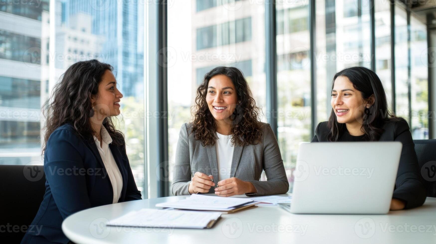 Diverse professionals learning data analytics with laptops in a modern workspace
